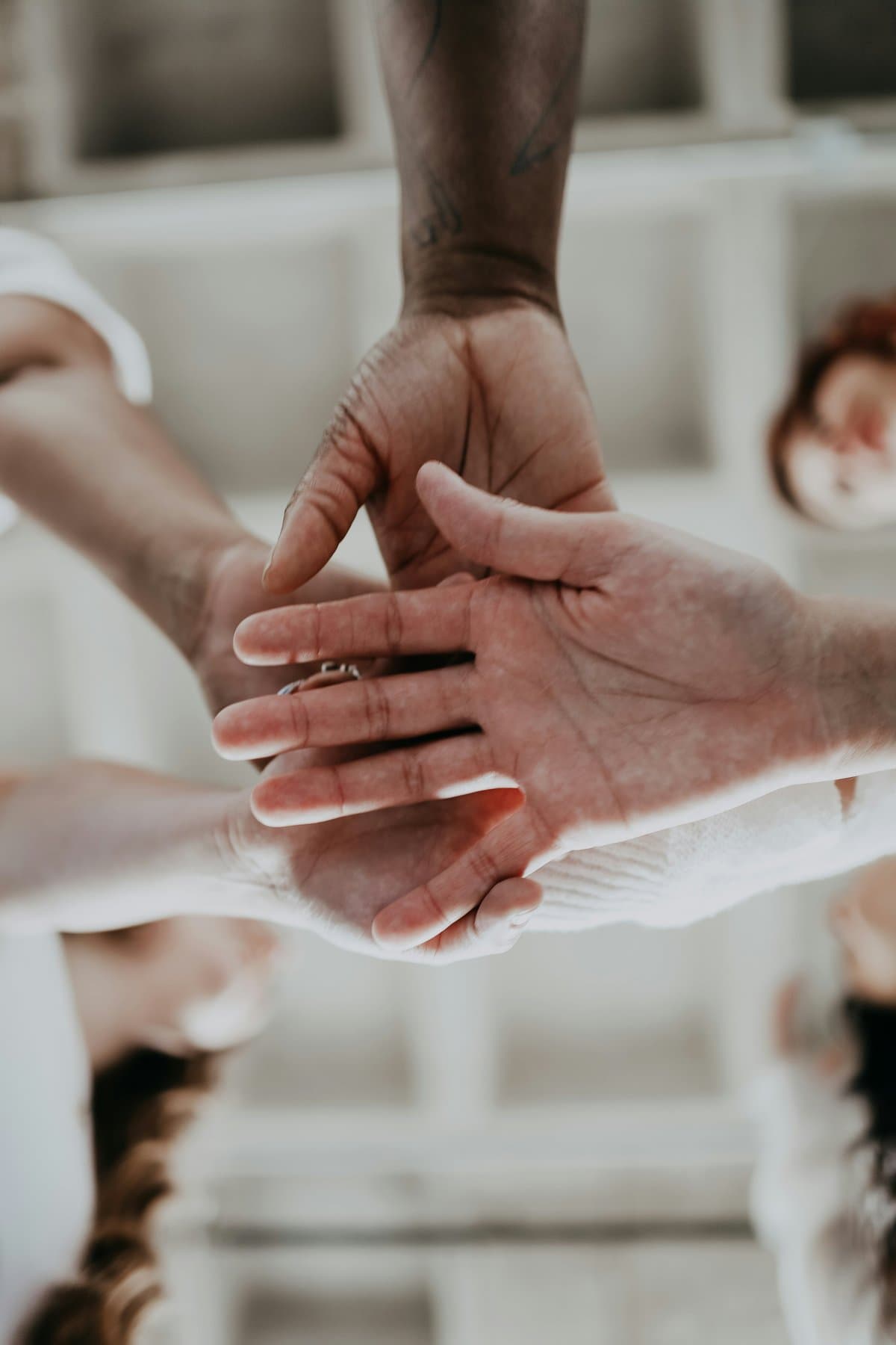 Theparkpay teammates stacking their hands together
