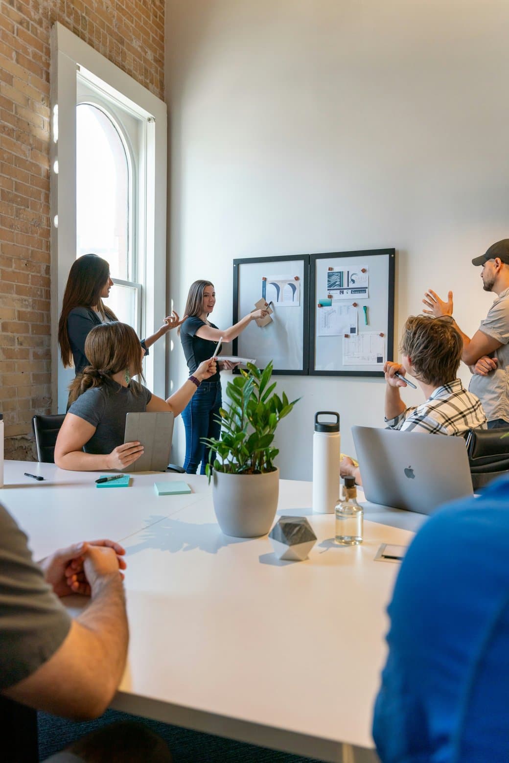 A Theparkpay team working through ideas together at a whiteboard