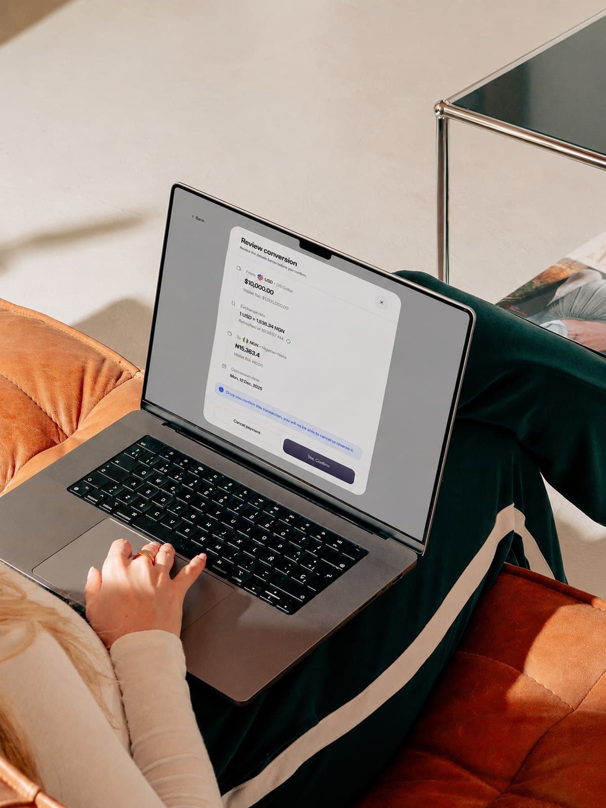 Reviewing a currency conversion on a laptop before confirming it.